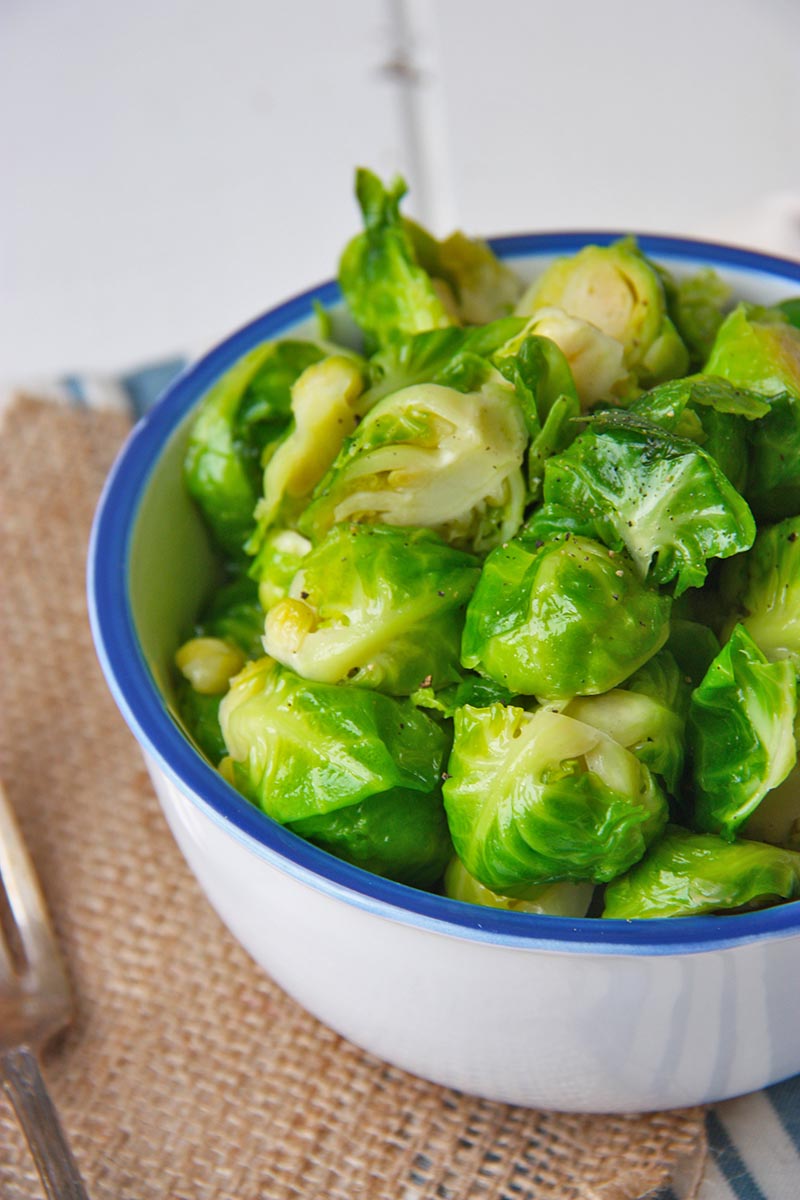 honey butter brussels sprouts in white and blue bowl