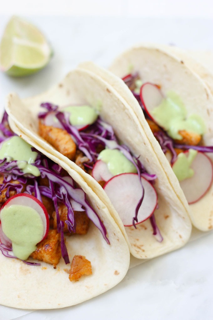 close up of healthy fish tacos wrapped in flour tortilla