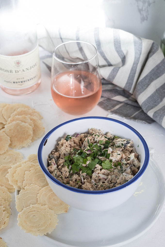 salmon dip in bowl in front of glass of wine