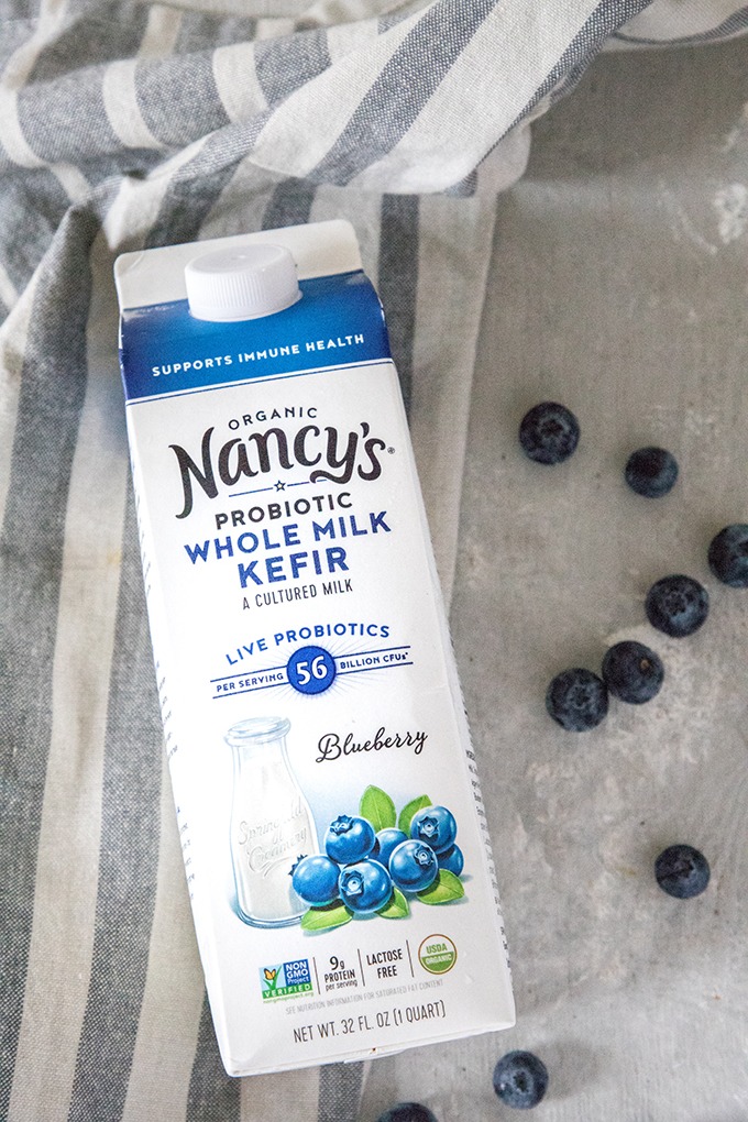 carton of nancy's organic whole milk blueberry kefir on grey board