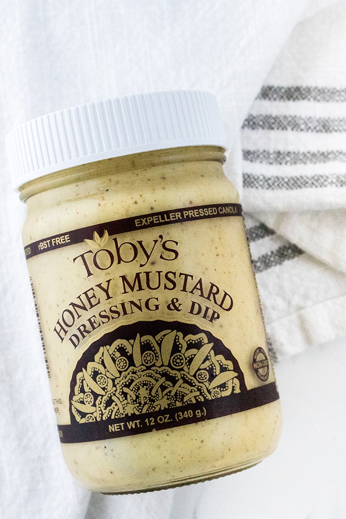 jar of Toby's Honey Mustard Dressing on a white linen