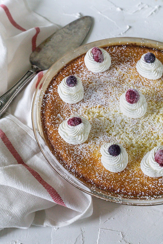 lemon coconut tart in pie dish, on red and white dish towel