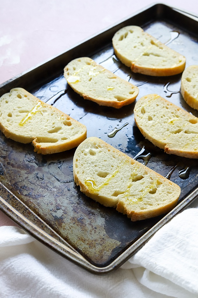 bread laid out on baking tray drizzled with olive oil