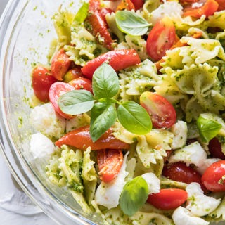 caprese pasta salad in a large glass salad bowl