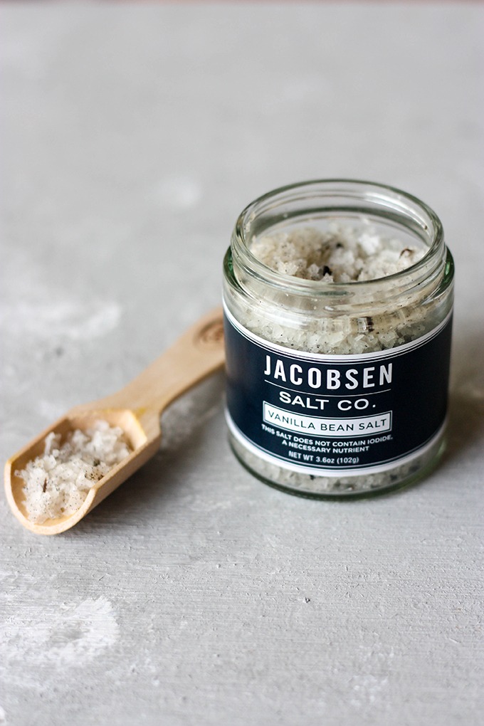 jar of jacobsen's vanilla sea salt next to wooden spoon full of salt