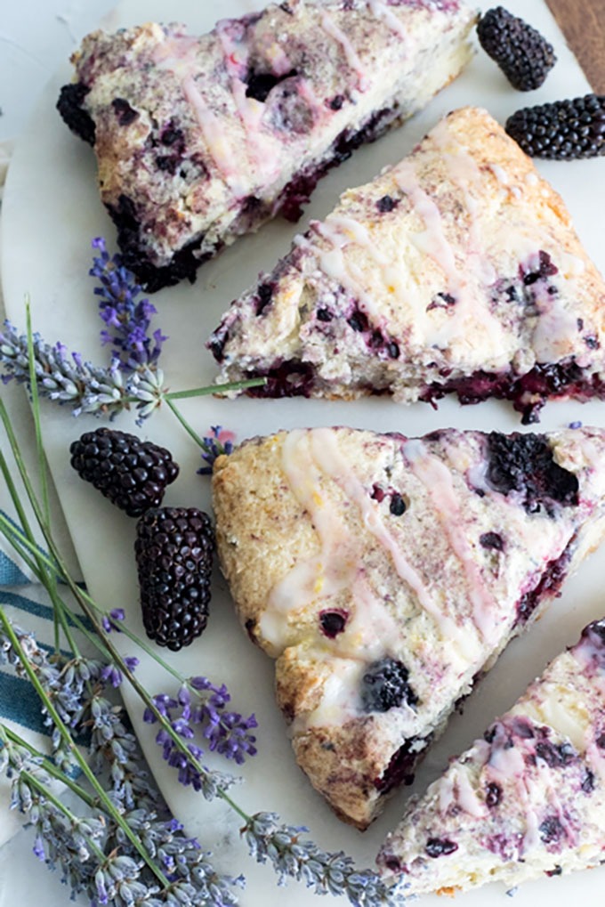 close up blackberry scones on marble board