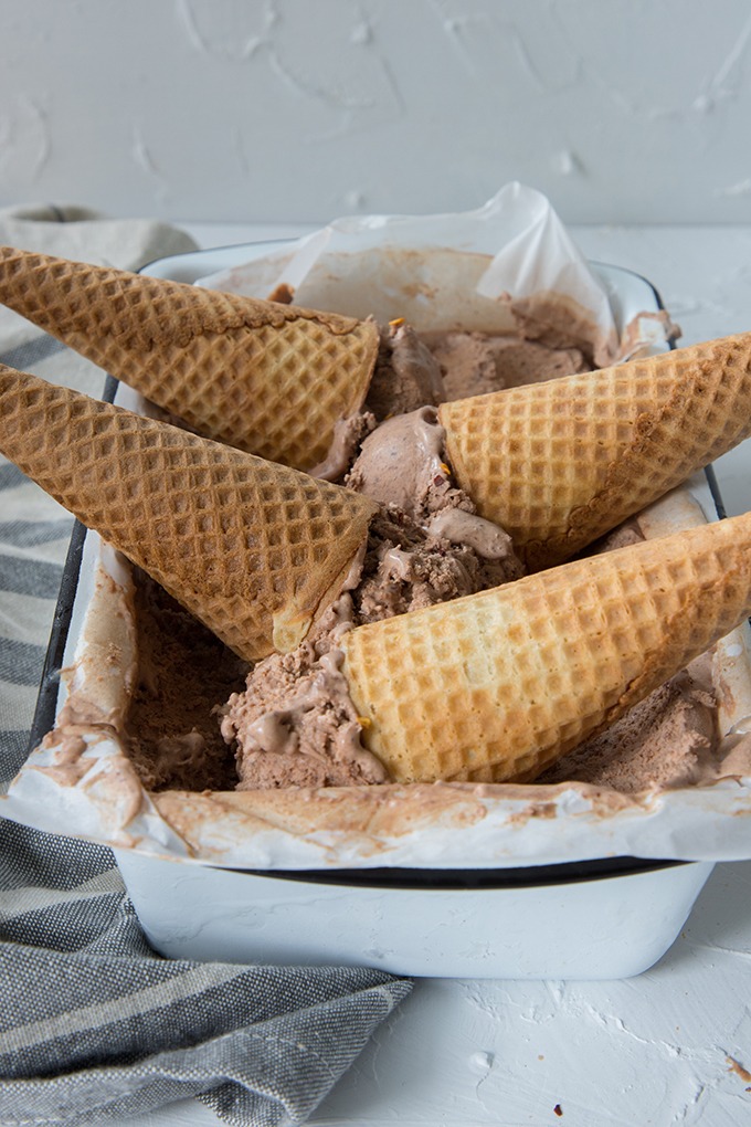 four upsdie down sugar cones in enamel tin of chili chocolate ice cream