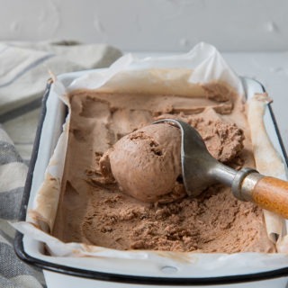 chili chocolate ice cream in enamel loaf pan with antique wooden ice cream scoop
