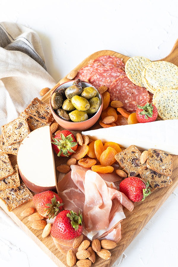 meat and cheese board featured on white background