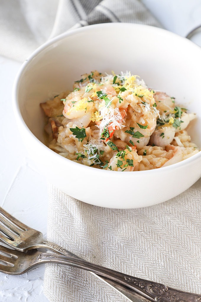 one bowl of prawn risotto on a rustic linen