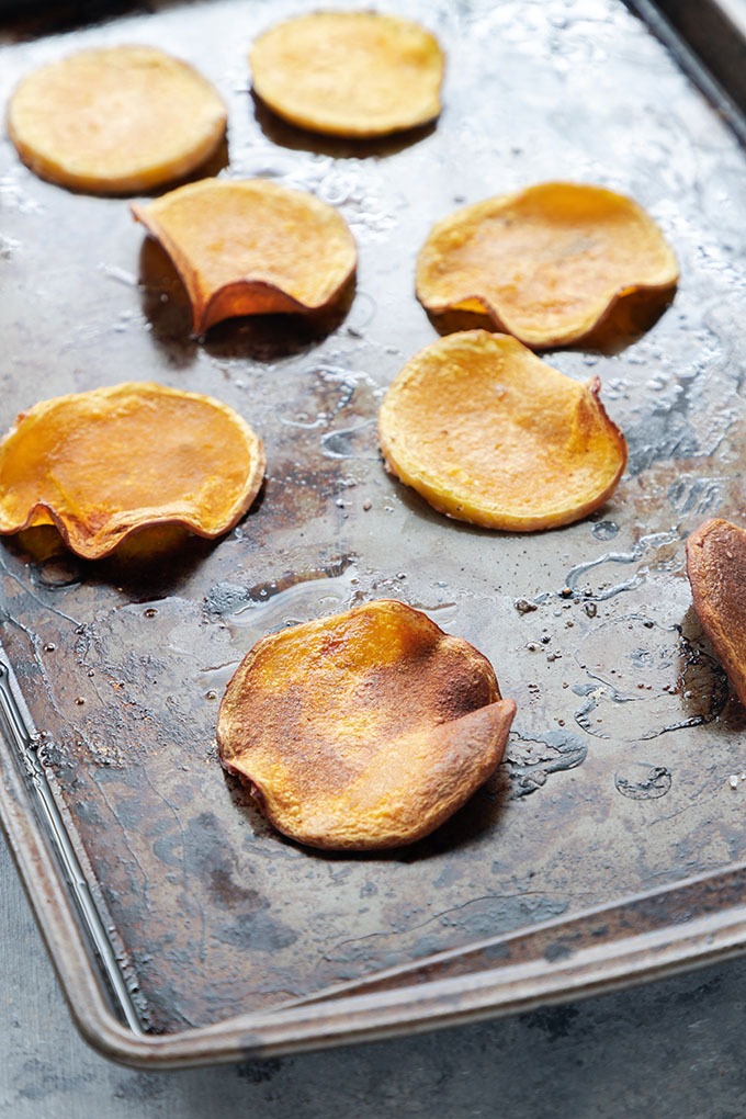 cooked butternut squash rounds on baking tray