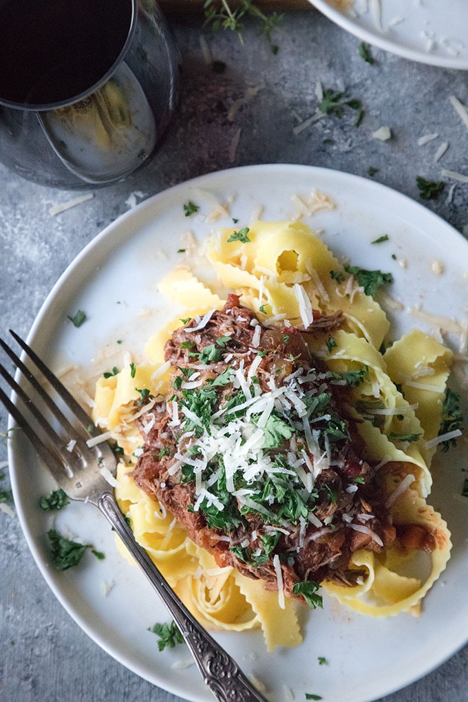 close up slow cooker beef ragu on white plate