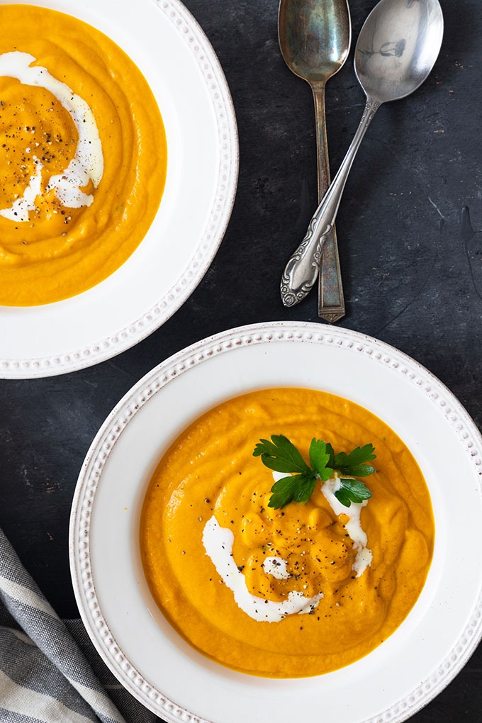 two bowls of carrot and ginger soup 