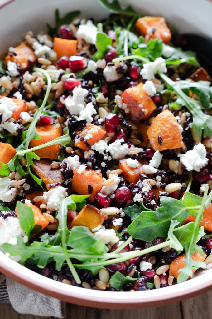 close up grain salad ingredients in white and brown bowl