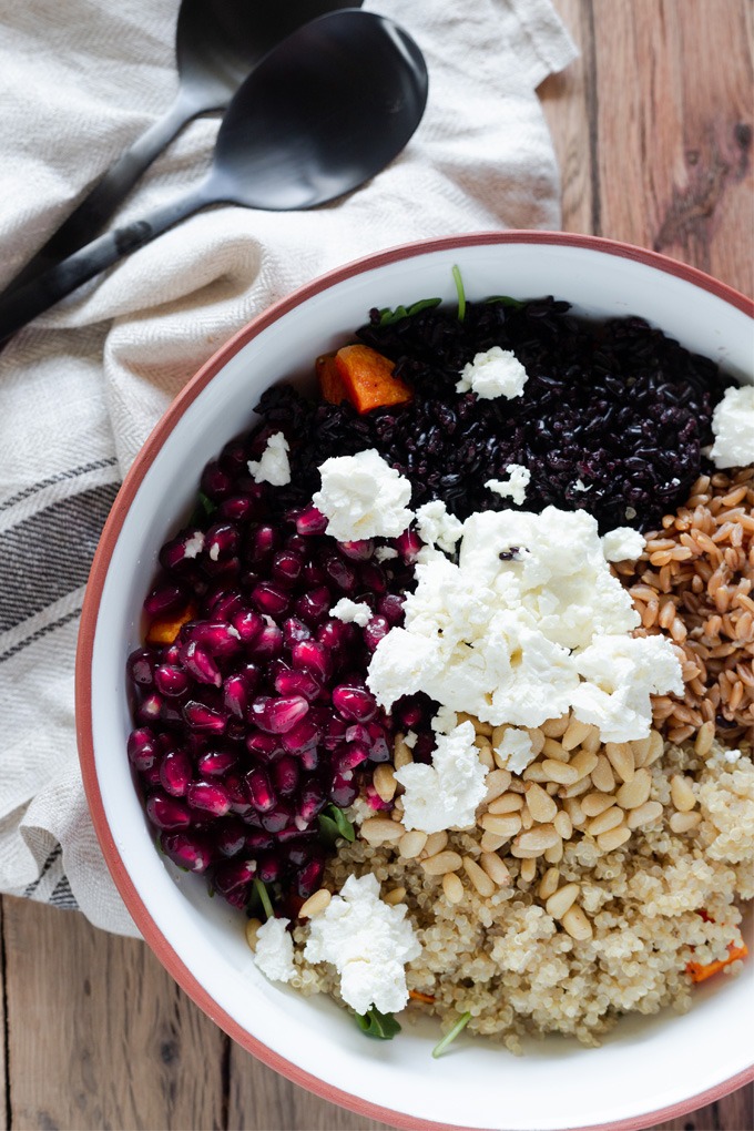 all ingredients for a grain salad in white and brown bowl, not tossed