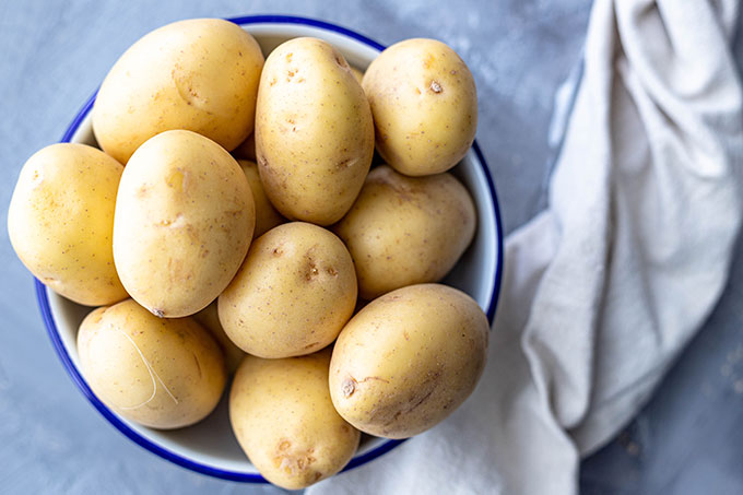 potatoes for pesto potato salad in white bowl
