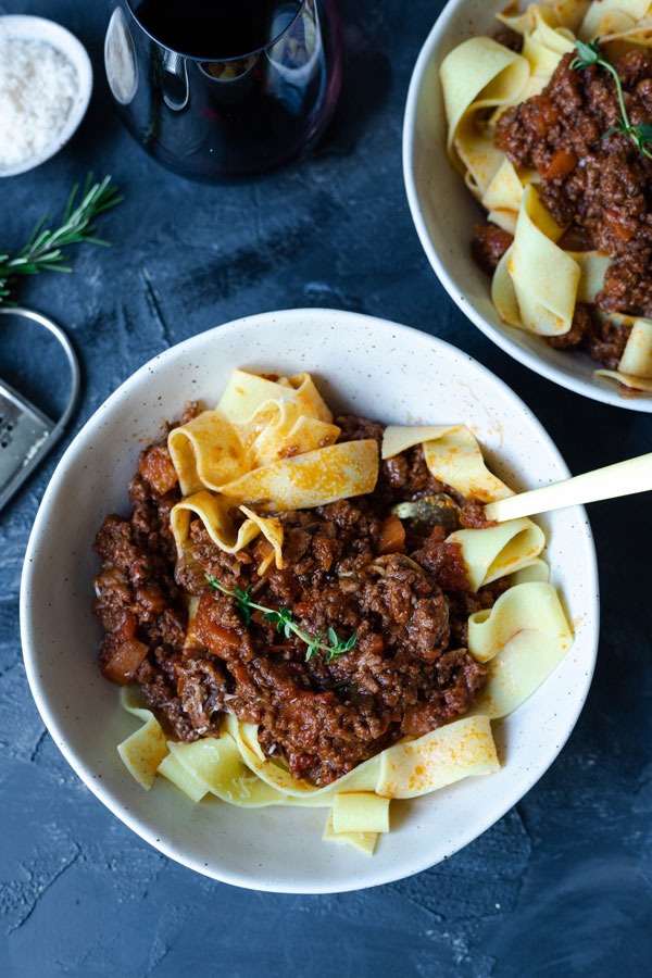 lamb ragu in bowls with fork