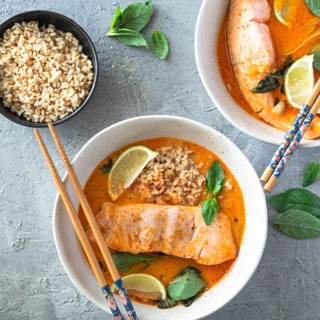 salmon curry in bowl with rice and chopsticks