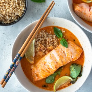salmon curry in bowl with rice and chopsticks