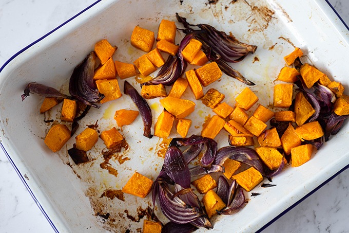 roast pumpkin and red onion in oven dish