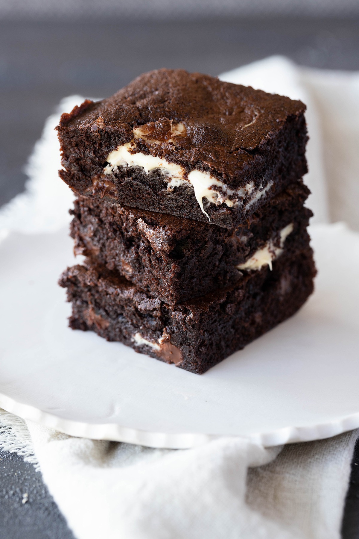 triple chocolate brownies on a white plate 