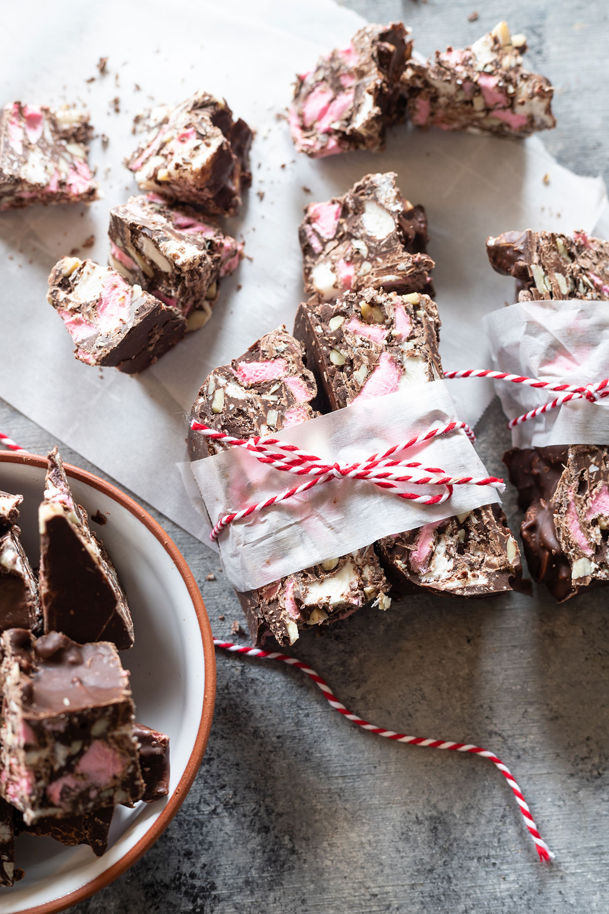 rocky road wrapped in parchment paper and ribbon on board