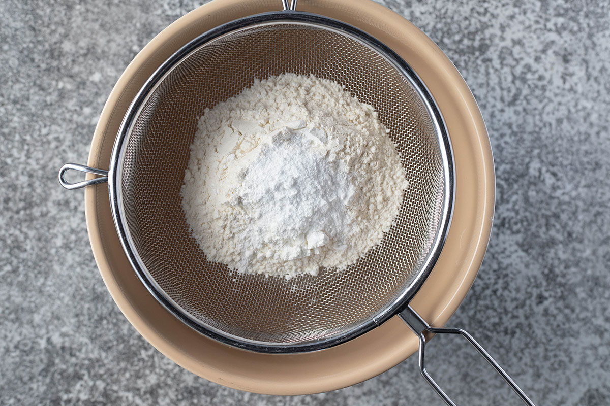 flour in a sieve over bowl