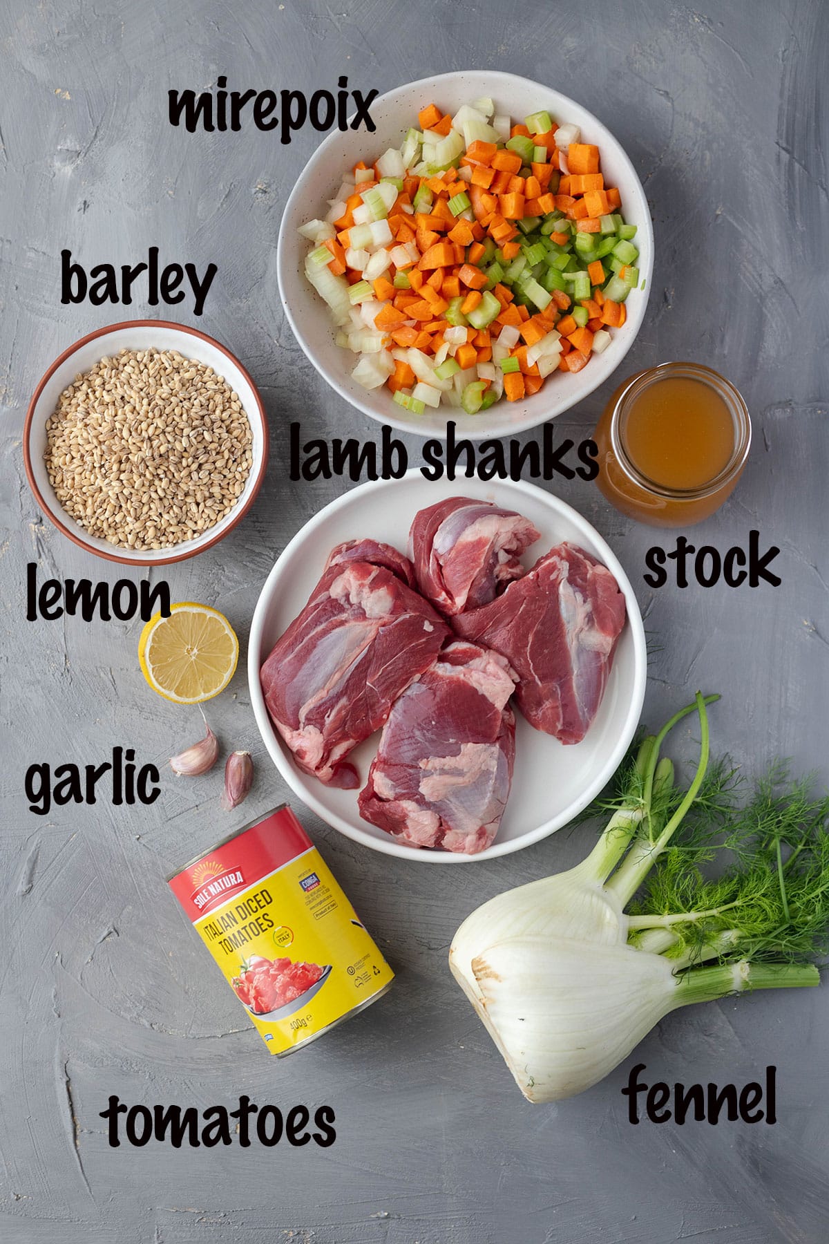 lamb shank soup ingredients shown top to bottom mirepoix, stock, lamb shanks, fennel, tomatoes, garlic, lemon and barley
