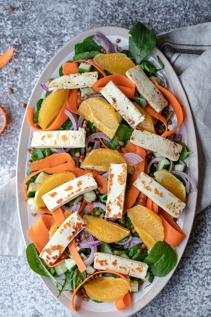 all salad ingredients except for the tahini dressing on a large, oval platter.