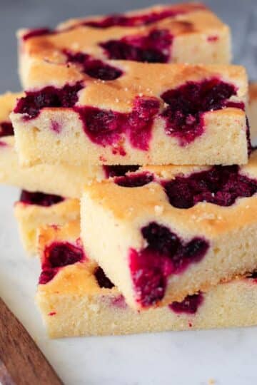 lemon sour cream cake on white marble board and knife