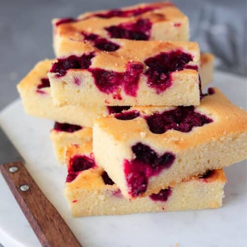 lemon sour cream cake on white marble board and knife