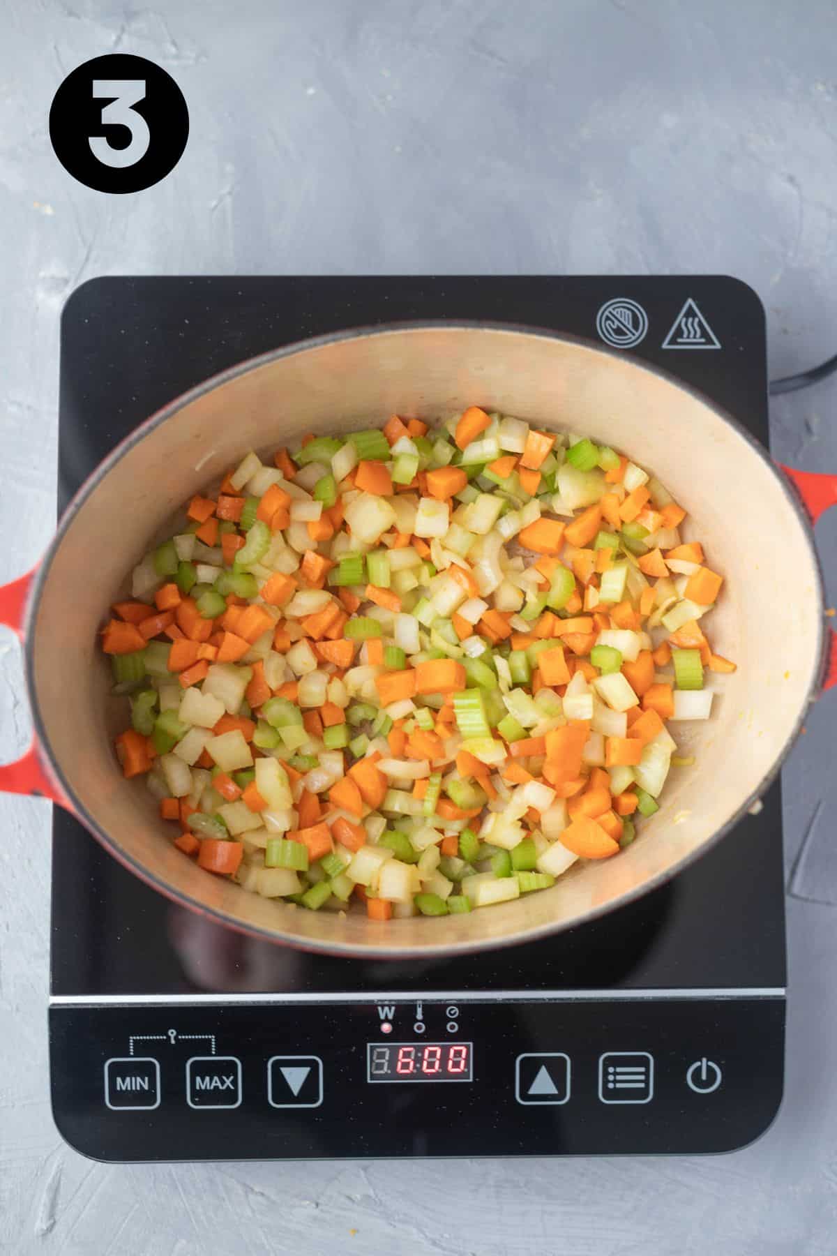 Carrot, celery and onion sautéing in Dutch Oven.