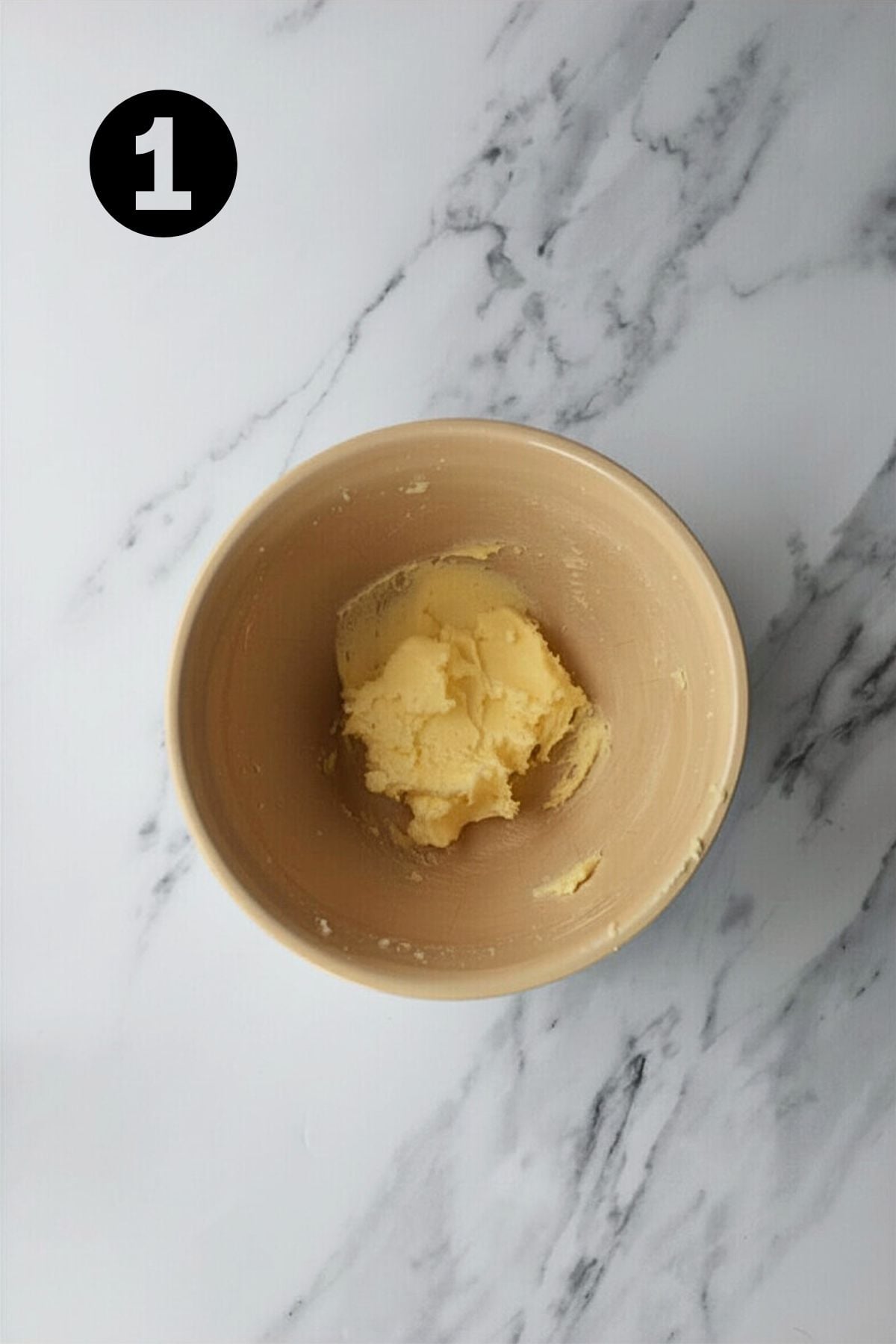 creamed butter and sugar in a large bowl on marble bench.