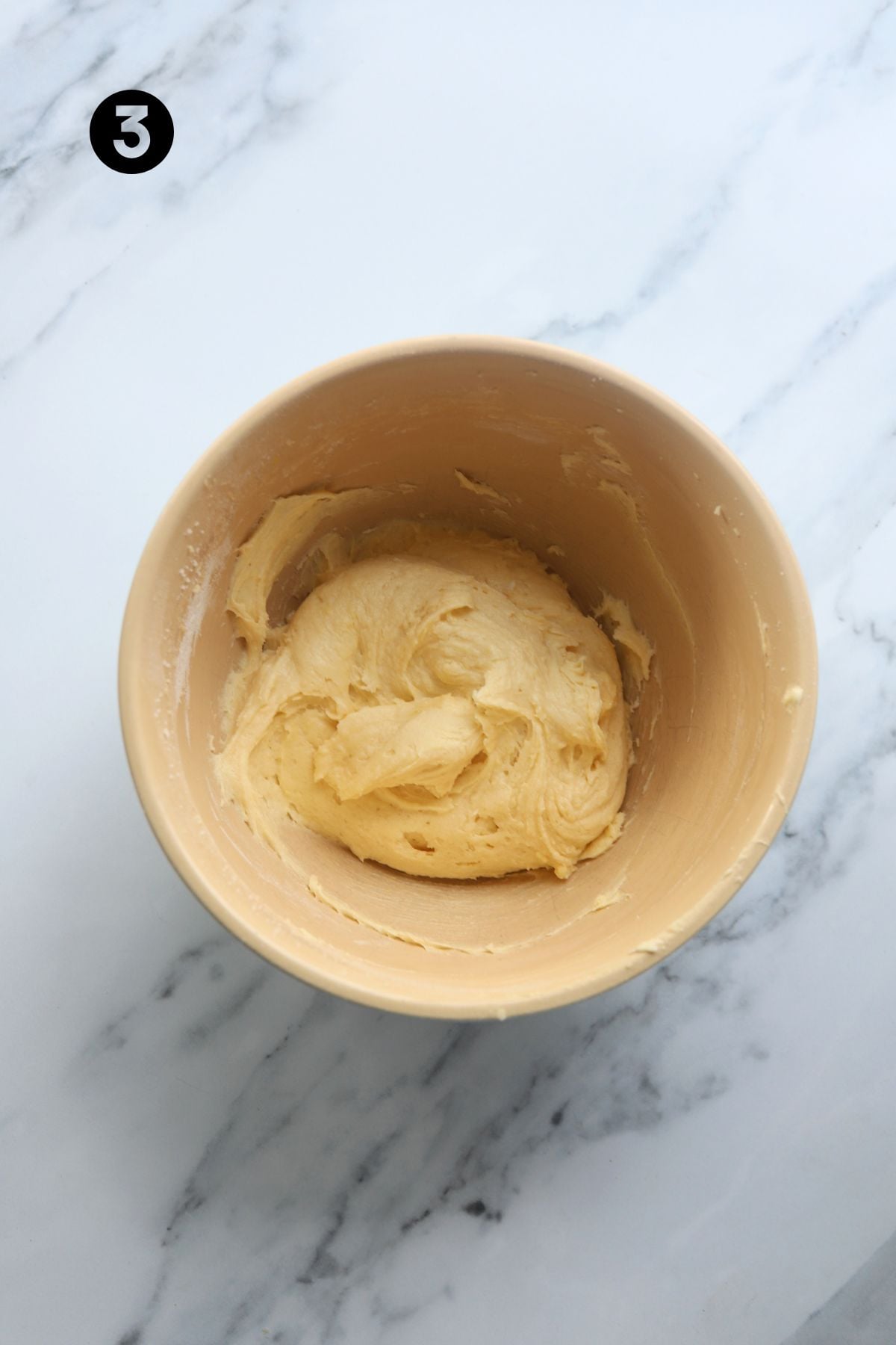 Flour added to the bowl. The batter has become a thicker consistency.