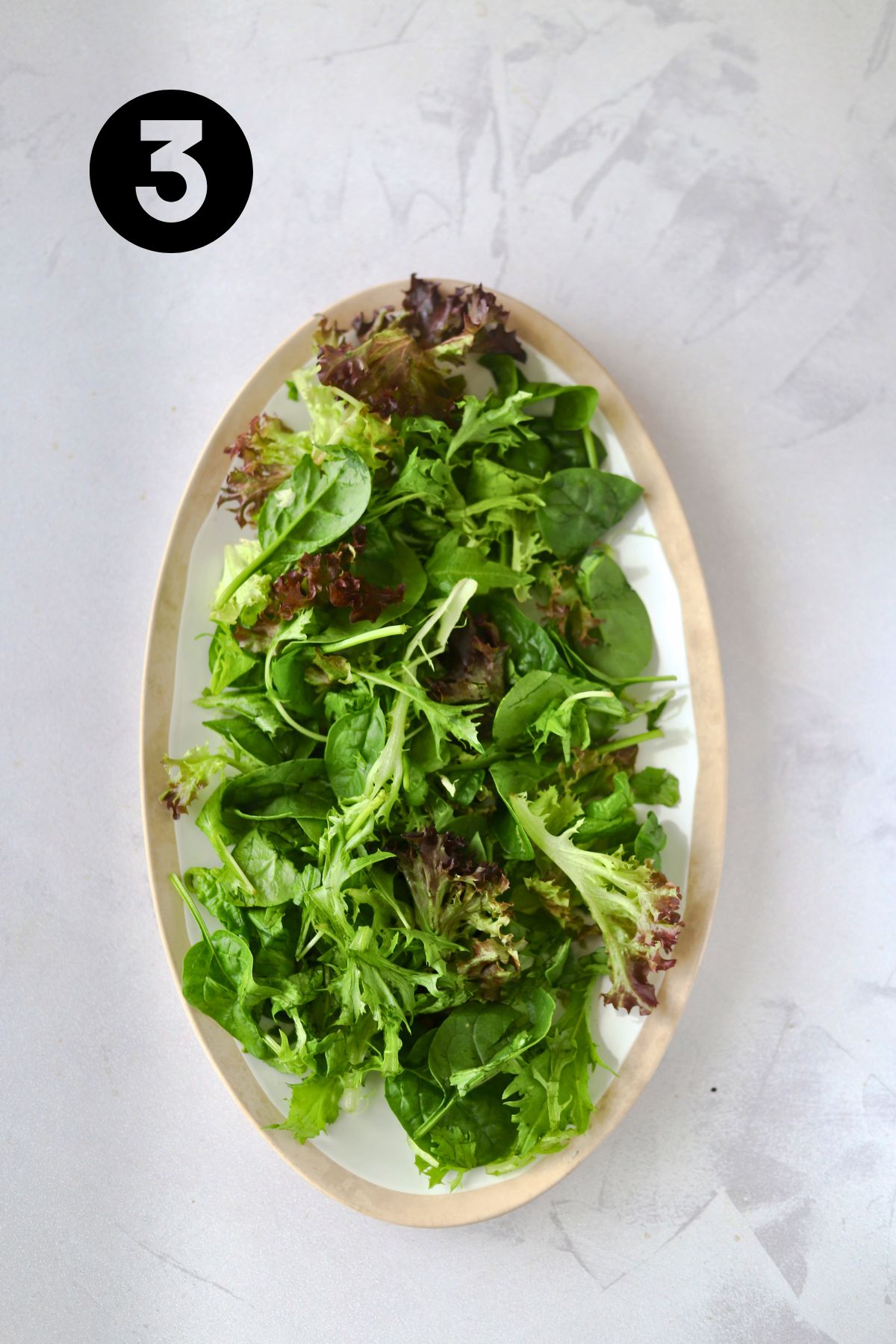 salad greens on a large platter.
